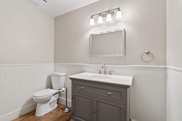 bathroom featuring hardwood / wood-style flooring, vanity, and toilet