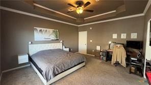 carpeted bedroom with crown molding and a raised ceiling