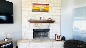 living room with a stone fireplace