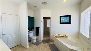 bathroom featuring tile patterned flooring and a tub