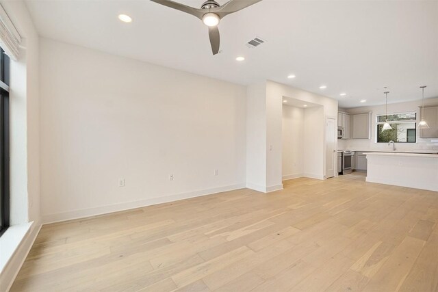 2050 Lohmans Spur Rd Unit 102, Lakeway, TX 78734 - unfurnished living room featuring light wood finished floors, recessed lighting, and ceiling fan