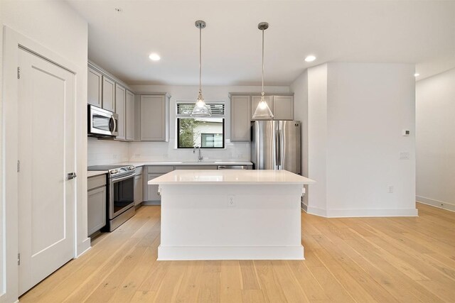2050 Lohmans Spur Rd Unit 102, Lakeway, TX 78734 - kitchen with appliances with stainless steel finishes, gray cabinets, decorative backsplash, light countertops, and recessed lighting