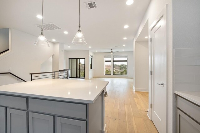 2050 Lohmans Spur Rd Unit 102, Lakeway, TX 78734 - kitchen with gray cabinetry, light countertops, and recessed lighting