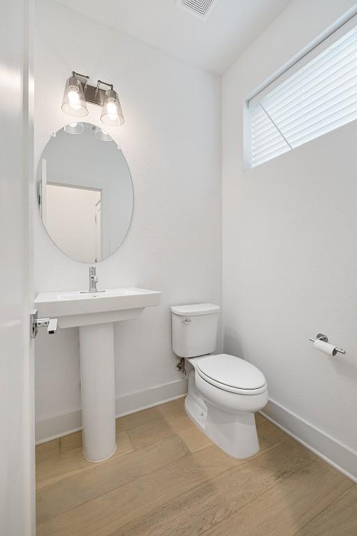2050 Lohmans Spur Rd Unit 102, Lakeway, TX 78734 - bathroom with toilet and wood finished floors