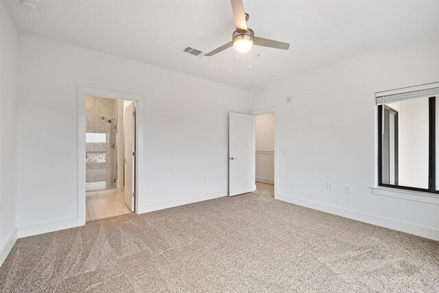 2050 Lohmans Spur Rd Unit 102, Lakeway, TX 78734 - unfurnished bedroom featuring light colored carpet, ensuite bath, and a ceiling fan