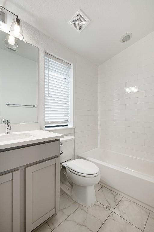 2050 Lohmans Spur Rd Unit 102, Lakeway, TX 78734 - full bath with marble look tiles, vanity, and shower / bathtub combination