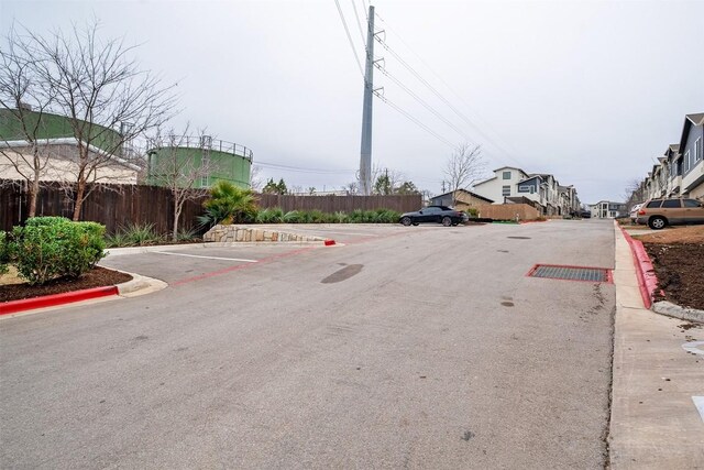2050 Lohmans Spur Rd Unit 102, Lakeway, TX 78734 - view of asphalt road featuring curbs and a residential view