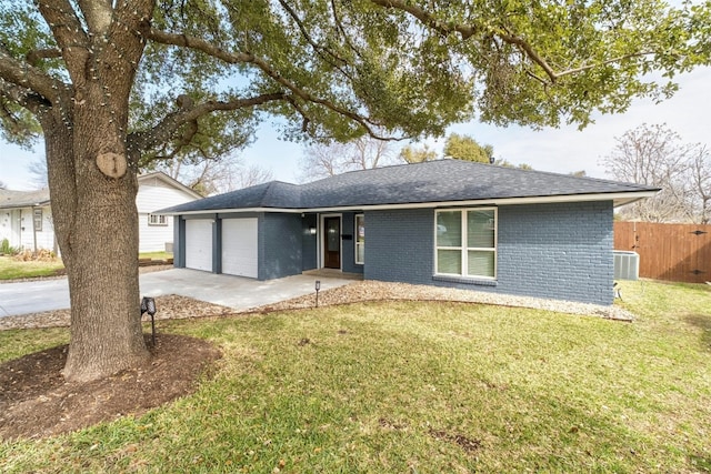 single story home featuring roof with shingles, an attached garage, central AC, a front lawn, and brick siding