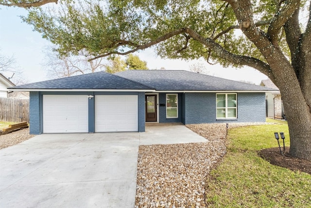 ranch-style home featuring roof with shingles, fence, an attached garage, brick siding, and driveway