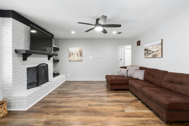 10113 Quail Hutch Dr, Austin, TX 78758 - living area with a ceiling fan, a brick fireplace, wood finished floors, recessed lighting, and baseboards