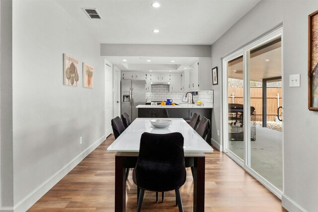 10113 Quail Hutch Dr, Austin, TX 78758 - dining area with baseboards, light wood-style flooring, and recessed lighting