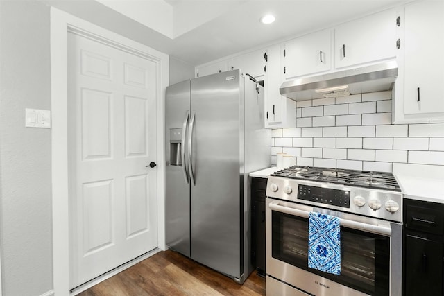 10113 Quail Hutch Dr, Austin, TX 78758 - kitchen with stainless steel appliances, under cabinet range hood, light countertops, dark wood finished floors, and decorative backsplash