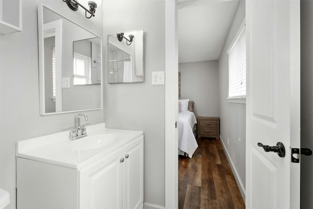 10113 Quail Hutch Dr, Austin, TX 78758 - bathroom with vanity, wood finished floors, baseboards, and connected bathroom