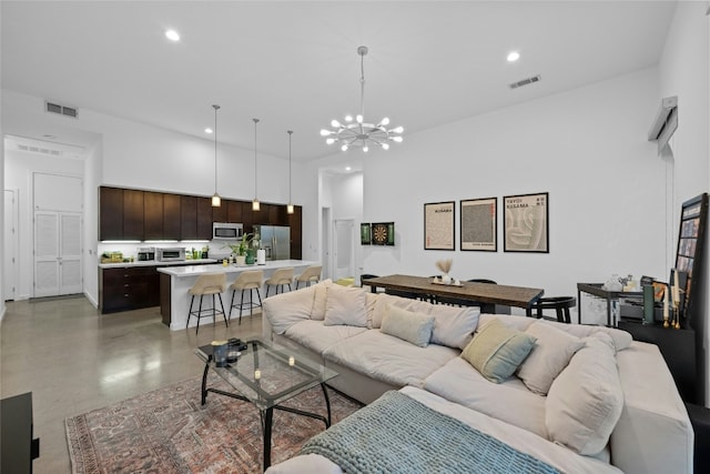 507 Sabine St Unit 907, Austin, TX 78701 - living area featuring a chandelier, recessed lighting, a high ceiling, and finished concrete flooring