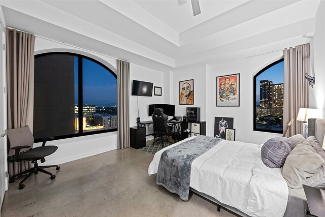 507 Sabine St Unit 907, Austin, TX 78701 - bedroom featuring finished concrete flooring, an office area, a ceiling fan, a raised ceiling, and multiple windows
