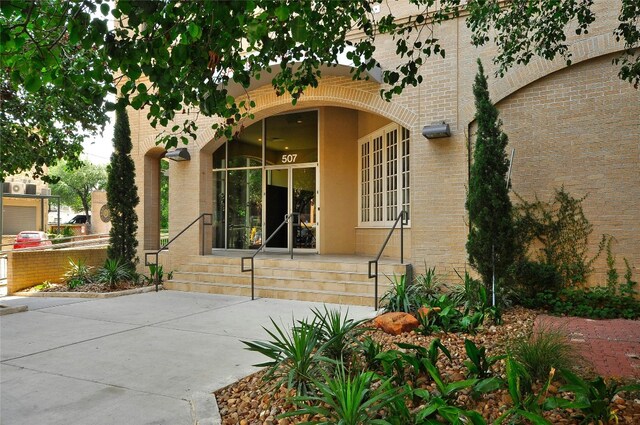 507 Sabine St Unit 907, Austin, TX 78701 - property entrance with brick siding and covered porch