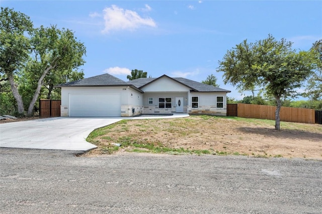 single story home with fence, driveway, and an attached garage