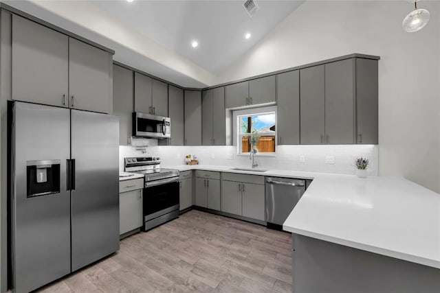 1514 Green Valley Ln, Granite Shoals, TX 78654 - kitchen with appliances with stainless steel finishes, gray cabinetry, tasteful backsplash, recessed lighting, and light wood-style flooring