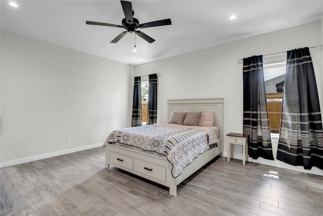 bedroom featuring light wood finished floors, ceiling fan, baseboards, and recessed lighting