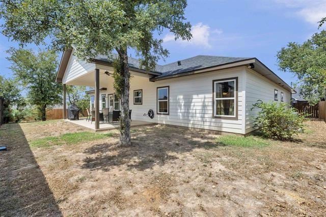 rear view of property with a patio area and fence