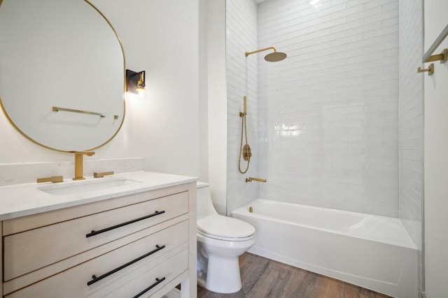 full bathroom with toilet, shower / bathing tub combination, wood finished floors, and vanity