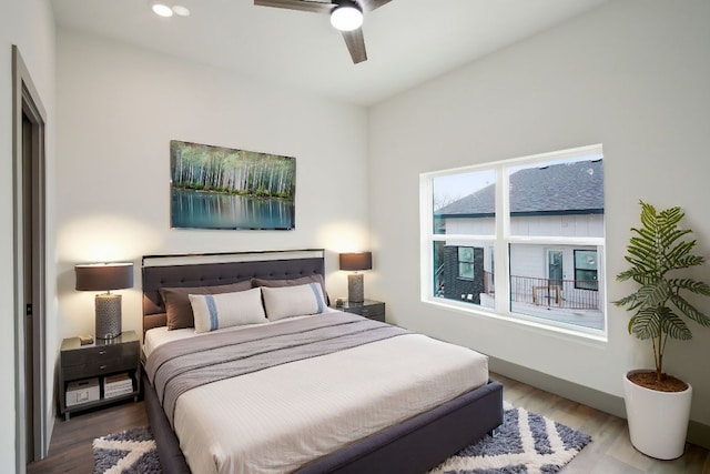 bedroom with a ceiling fan, wood finished floors, and recessed lighting