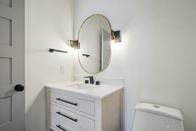 half bathroom with toilet and vanity