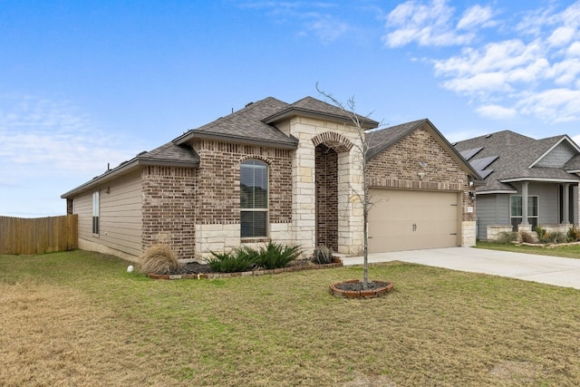 view of front of home with a garage and a front lawn