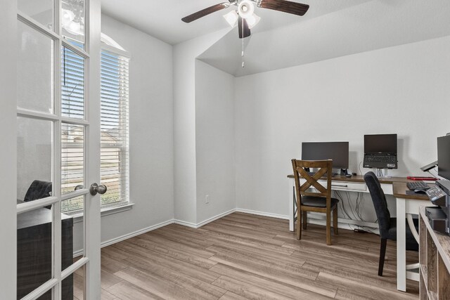 office with french doors, ceiling fan, and light hardwood / wood-style flooring