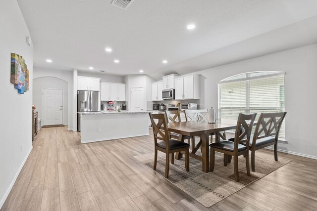 dining room with light wood-type flooring