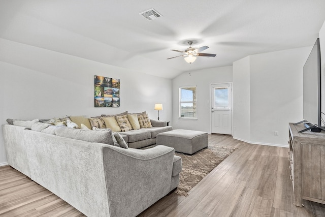 living room featuring lofted ceiling, ceiling fan, and light hardwood / wood-style flooring
