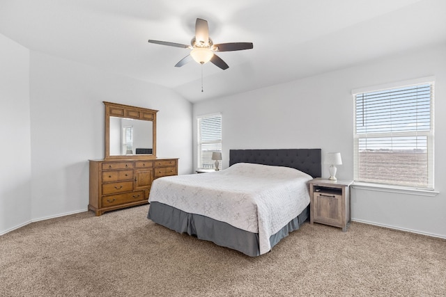 carpeted bedroom with ceiling fan and lofted ceiling