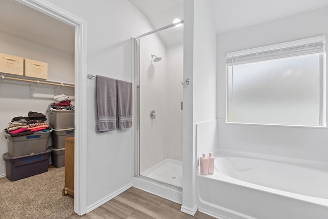 bathroom with shower with separate bathtub