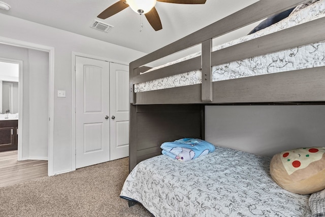 bedroom featuring carpet, ceiling fan, and a closet