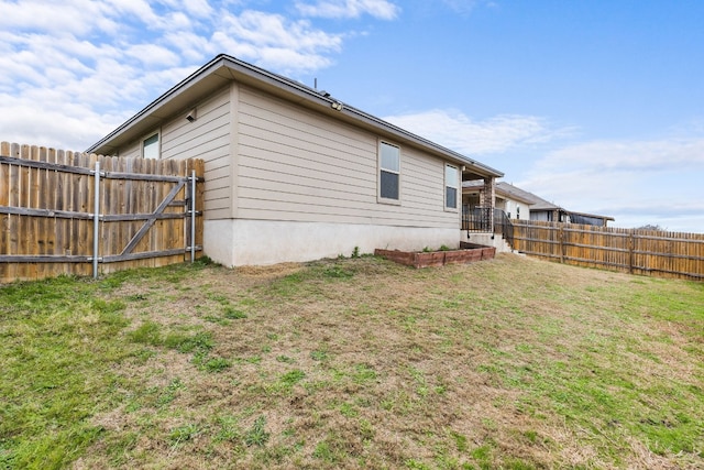 view of side of home with a yard