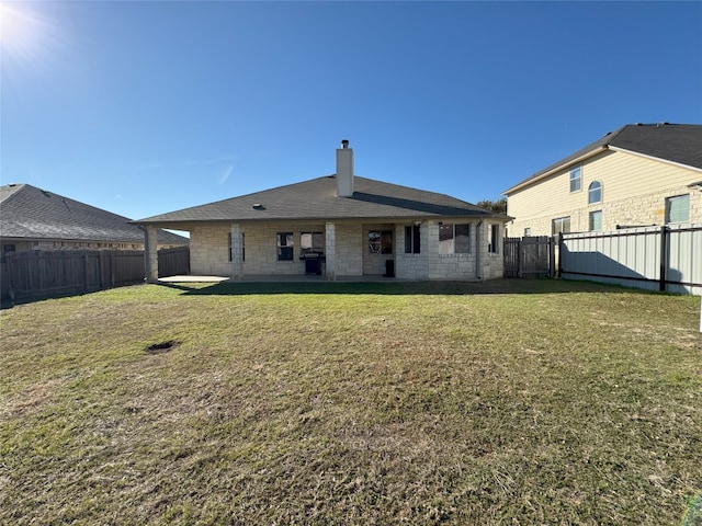 back of house with a yard