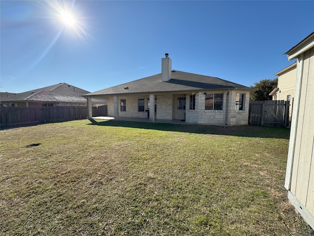 back of property featuring a yard