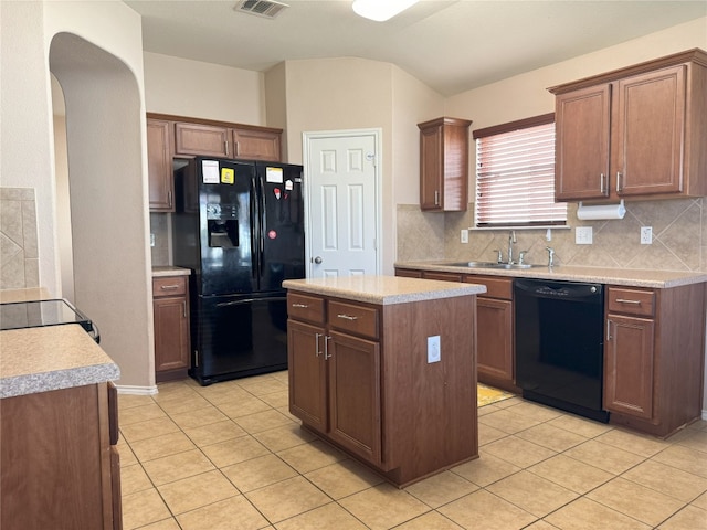 kitchen featuring sink, backsplash, black appliances, and a kitchen island