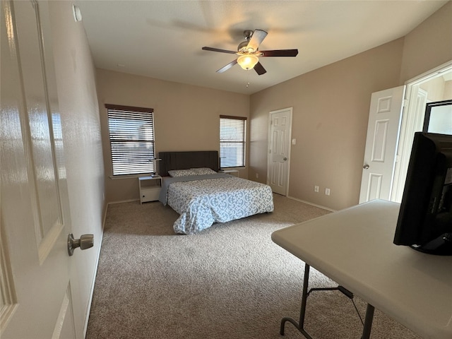 bedroom featuring ceiling fan and carpet