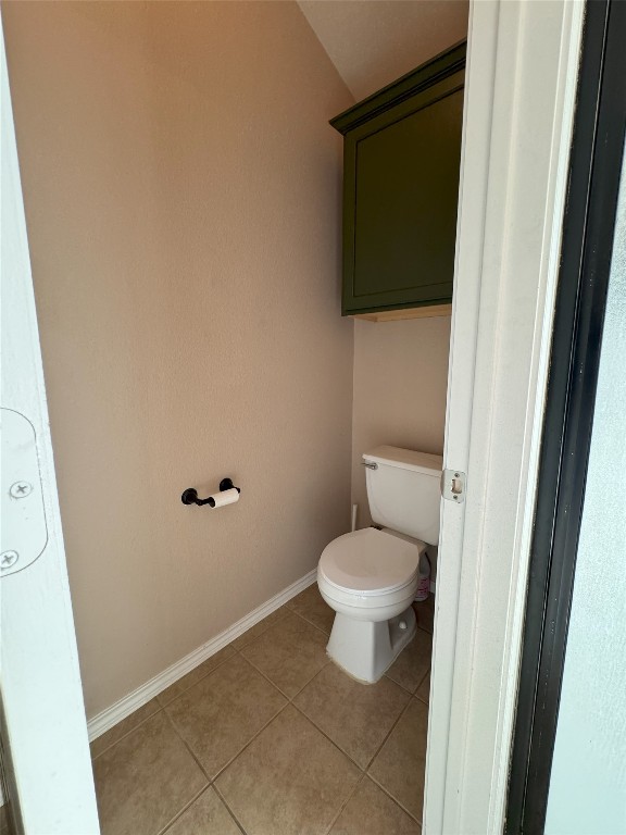 bathroom featuring tile patterned floors and toilet