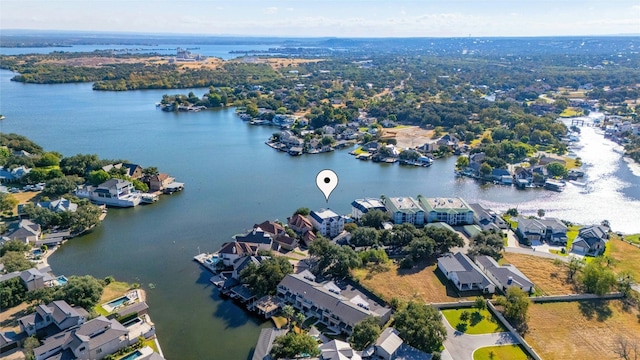 drone / aerial view featuring a residential view and a water view