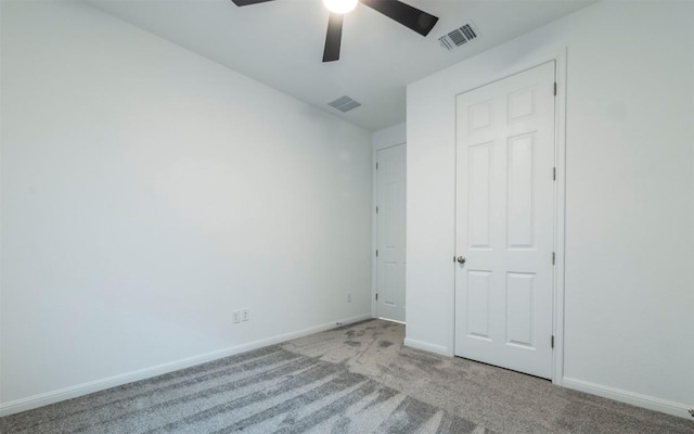 unfurnished bedroom with carpet, visible vents, and baseboards