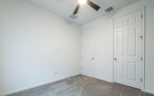 unfurnished bedroom featuring a ceiling fan, carpet flooring, visible vents, and baseboards