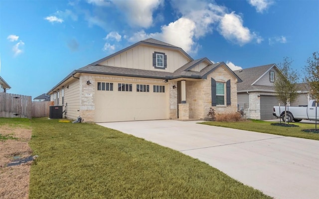 view of front facade with a garage, driveway, fence, a front lawn, and central AC