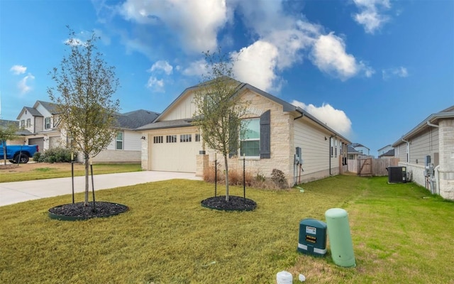 single story home with concrete driveway, fence, a front lawn, and central air condition unit