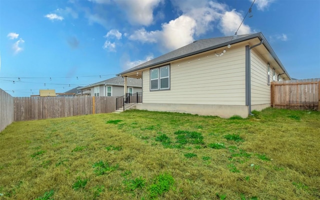 exterior space featuring a fenced backyard and a yard