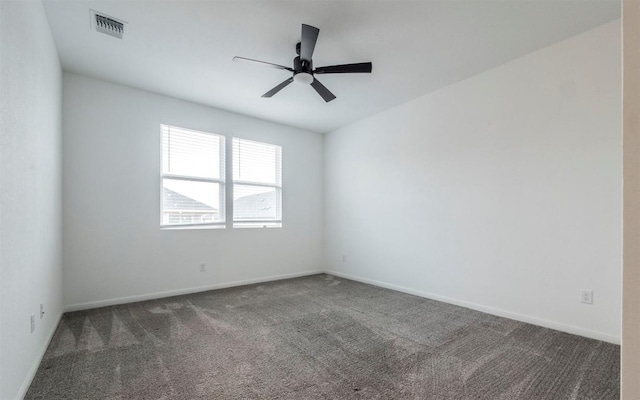 carpeted empty room with ceiling fan, visible vents, and baseboards