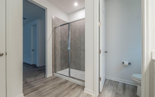 228 Citation Dr, Jarrell, TX 76537 - full bath featuring a stall shower, wood finished floors, toilet, and baseboards