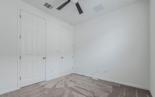 unfurnished bedroom featuring baseboards, visible vents, and carpet flooring