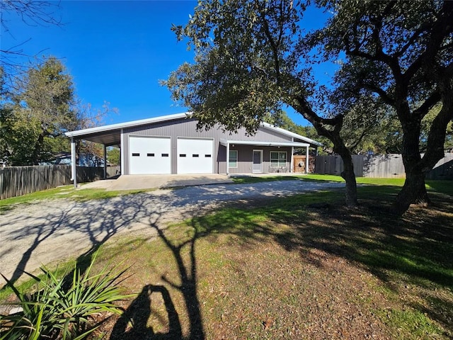 exterior space featuring driveway and fence